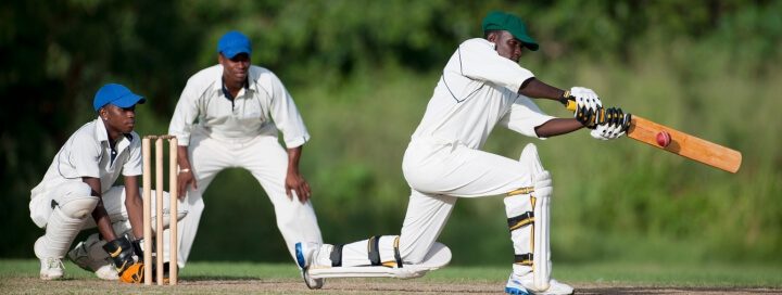 3 men playing cricket