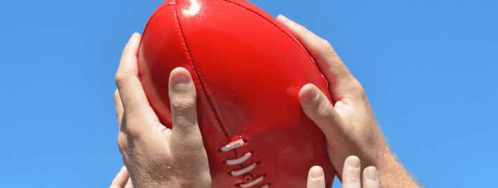 Hands Catching AFL Ball