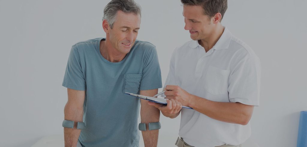 Orthopedic Therapist speaking with a male patient.