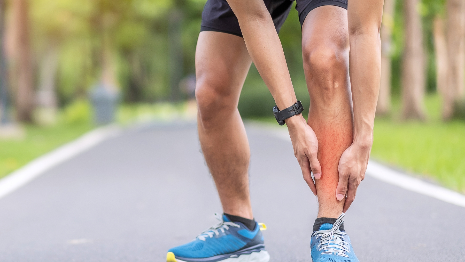 Runner holding shins due to shin splints