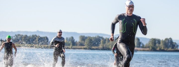 Participants in Triathlon running in ocean