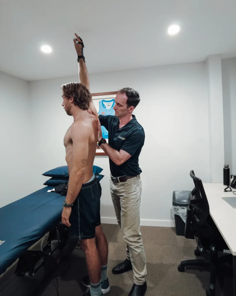 Man having range of motion assessed by clinician.