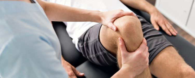 A knee being massaged